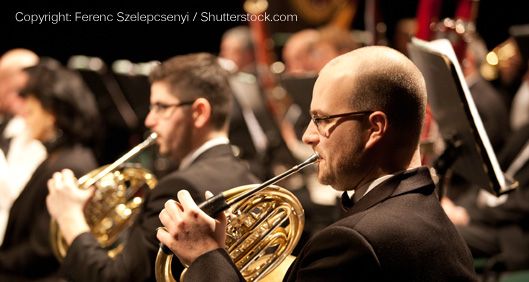 French horn players in an orchestra