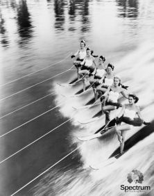 black and white image of a row of women water skiing