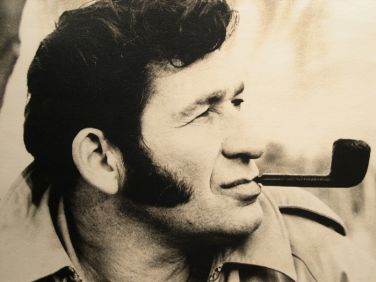 black and white image of a man smoking a pipe