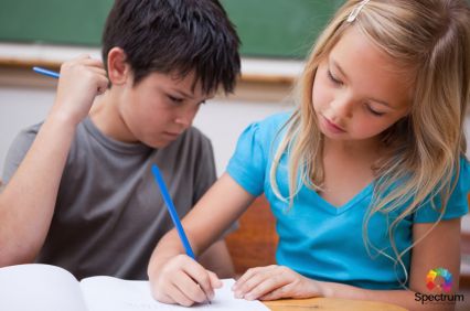 two children writing in notebook