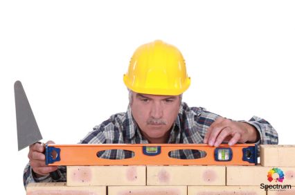 male measuring bricks